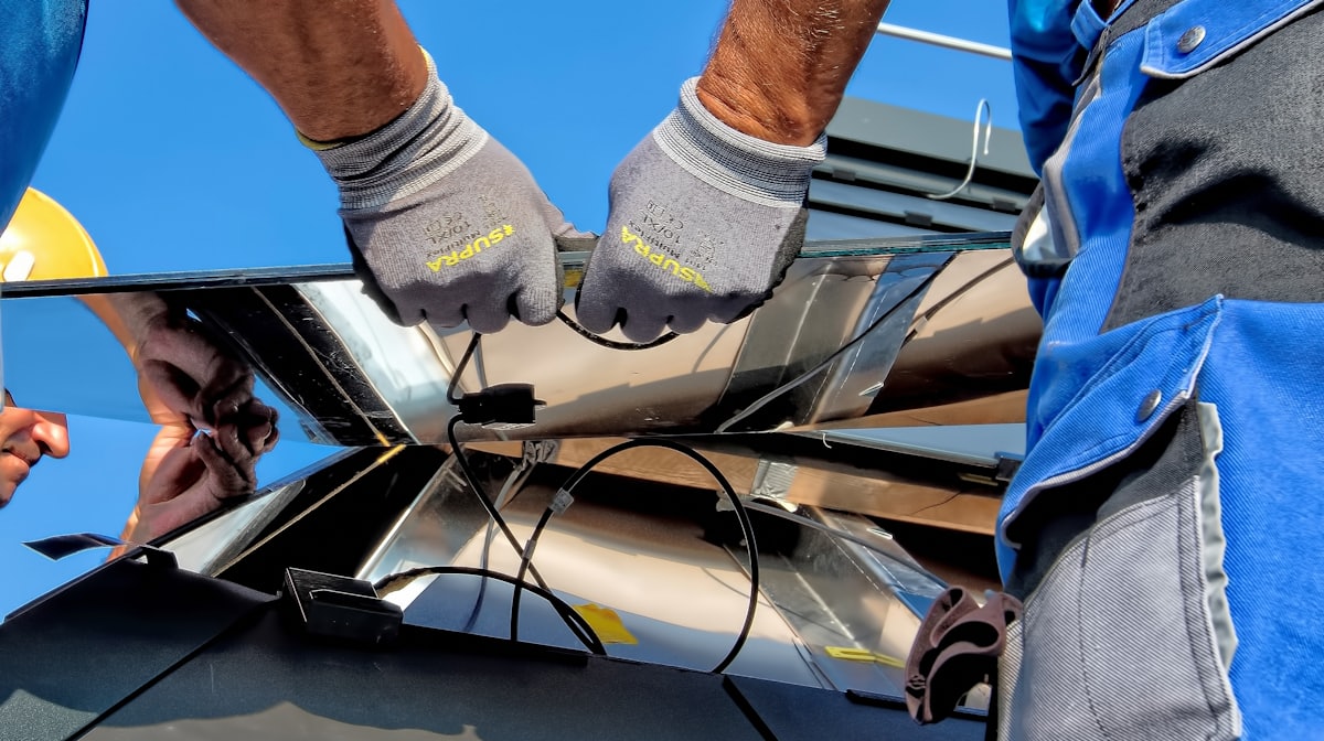 Technicians installing solar PV modules